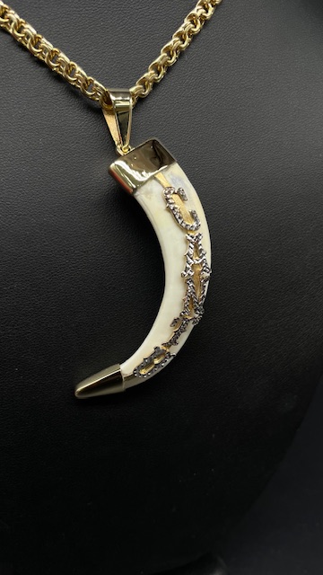 Custom carved gold pendant at Tamayo's Jewelry